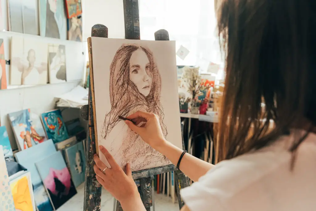 An artist drawing on a canvas