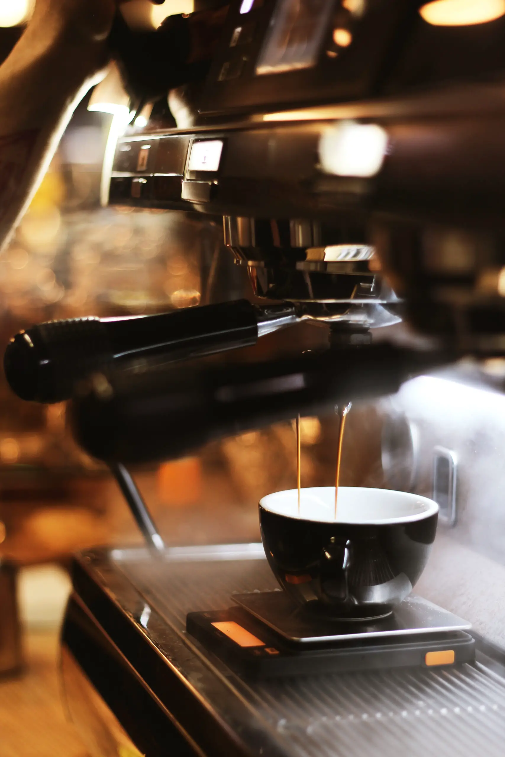Black espresso maker with cup